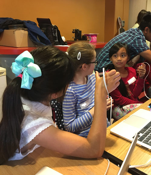 Girls playing a guessing game using the micro:bit
